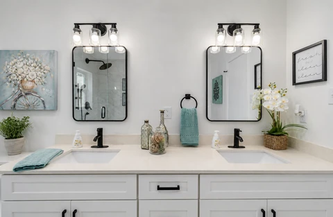 Bathroom remodel in Dallas, TX with double vanity and framed mirrors