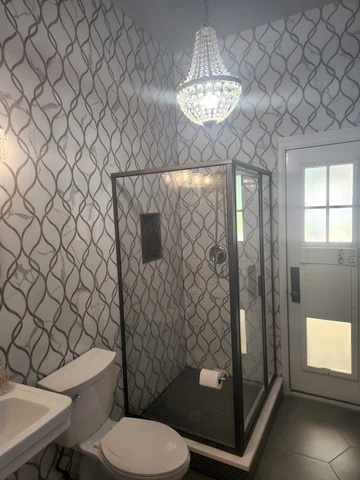Garland, TX bathroom remodel with patterned wall tile and glass shower