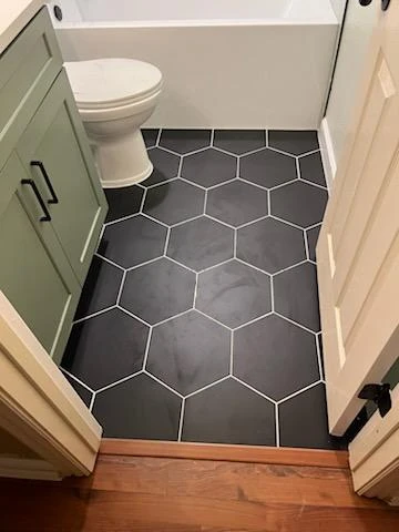 Hexagon floor tile in a bathroom remodel in The Colony, TX