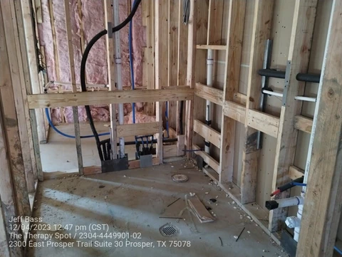 Plumbing rough-in inside framed commercial walls in Prosper, TX