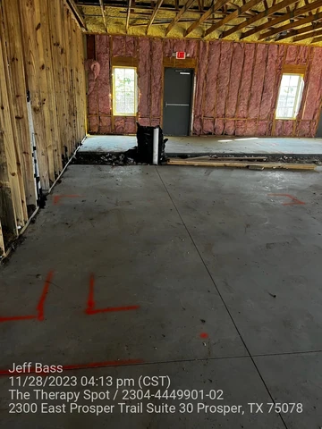 Wall layout marked on the slab during commercial framing in Prosper, TX