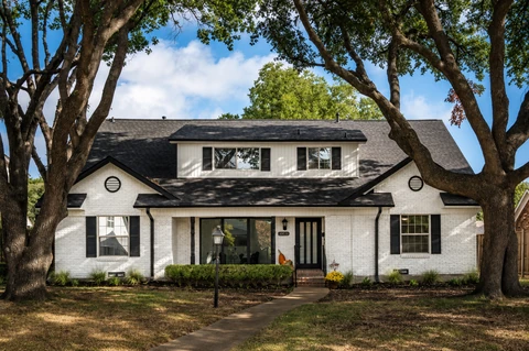 Dallas, TX home exterior with freshly painted brick and black shutters