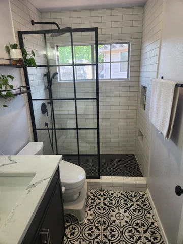 Guest bathroom remodel in Richardson, TX with a glass shower panel and patterned floor tile
