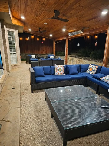 Covered patio in Garland, TX with sectional seating and a cedar ceiling