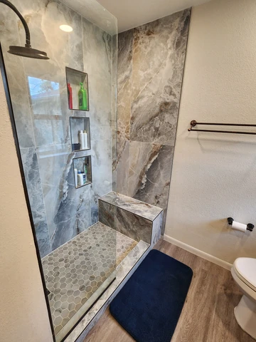Marble-tile shower replacing a tub in a Garland, TX bathroom
