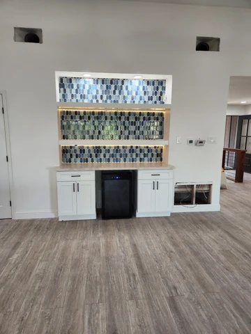 Custom wet bar with modern cabinetry and tile backsplash in Dallas, TX